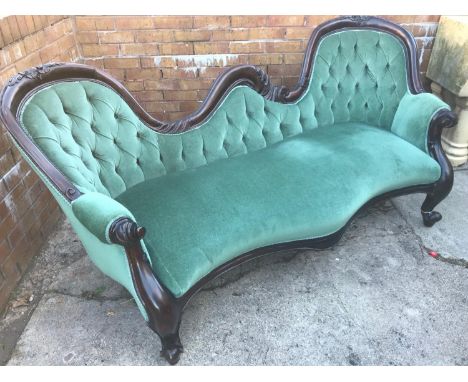A large antique reproduction 3 seat parlour couch. Styled with green material and button back 