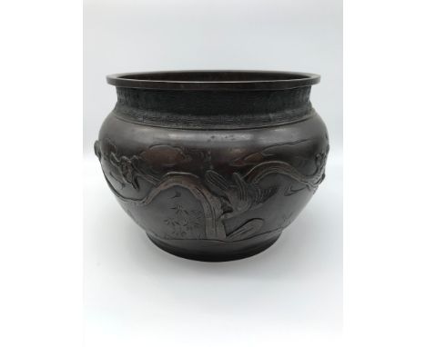 A Japanese bronze planter depicting birds flying. Measures 17cm in height &amp; 25cm in diameter 