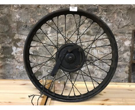 Vintage motorbike wheel, possible from a Triumph X model 