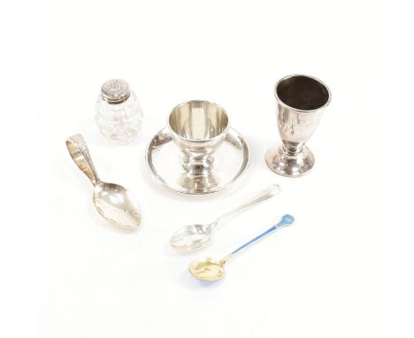 An assorted collection of silver breakfast utensils. The lot to include; An egg cup with saucer base (hallmarked for Birmingh