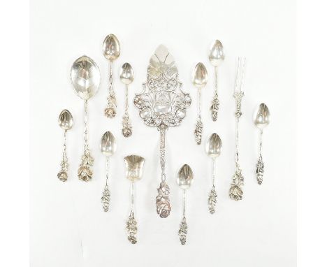 A collection of floral handled flatware. The silver to include an 800 silver cake slice, an 835 silver leaf bowled spoon havi