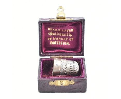 An early 20th Century antique Henry Fidkin thimble in fitted box. The thimble having engraved decoration throughout and set w