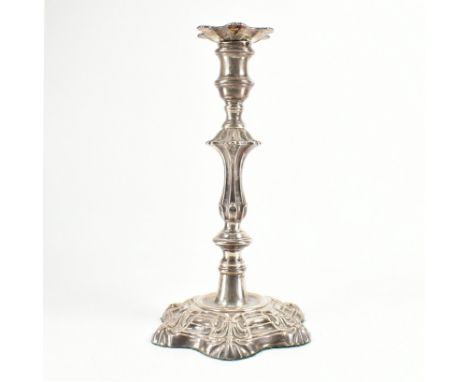 A George III hallmarked silver candlestick. The Georgian candle stick in the regency style having a hexafoil petal base.&nbsp