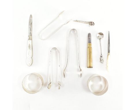 An assortment of silver and pearl items. The lot to include a pair of napkin rings. The first ring having an engine turned pa