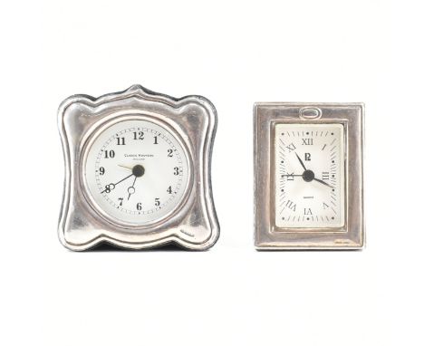 A pair of silver fronted clocks. The first a Classic Nouveau England clock with circular white dial &amp; Arabic numeral indi