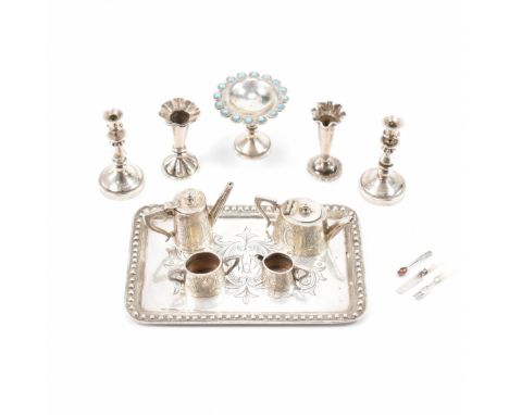 A collection of vintage silver dolls house tableware. The lot to include a teapot, water pot, double handled creamer, sugar p