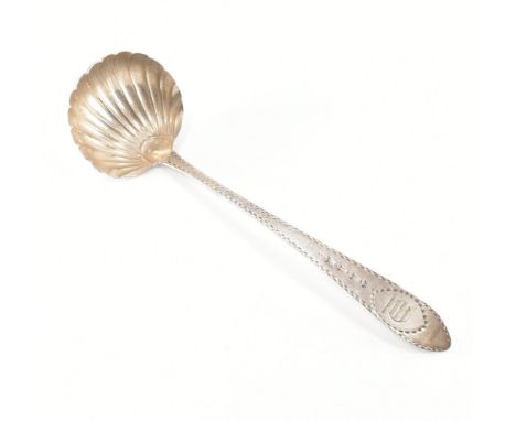 Irish silver hallmarked ladle with clam shell bowl and chased handle decoration. Hallmarks illegible - attributed John Smith 