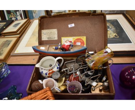 A selection of curios and trinkets including toy boat and postage scales
