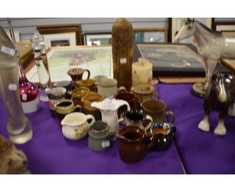 A selection of ceramic water milk snd cream jugs most being salt glazed