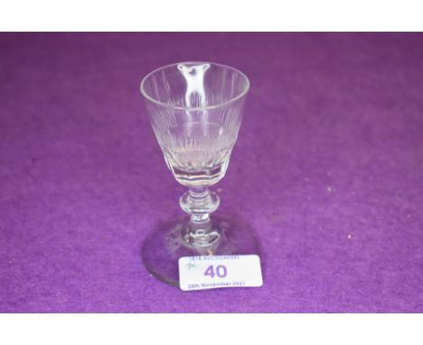 A small wine glass with central knop to stem and decoration to bowl.