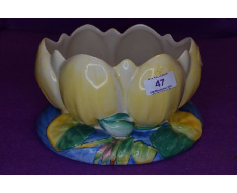 A Clarice Cliff lily pad bowl in blue and yellow, marked for Newport Pottery to underside.