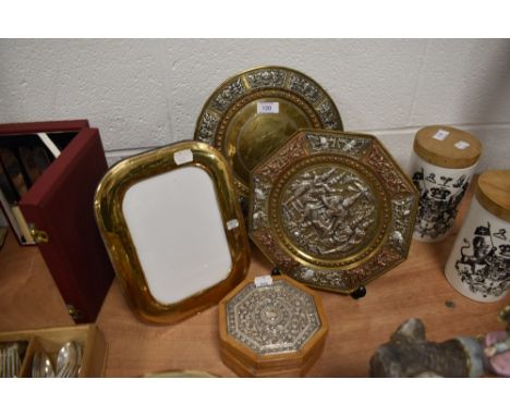 Two Indian silver decorated embossed plates and a similar trinket jewellery case and sterling silver picture frame