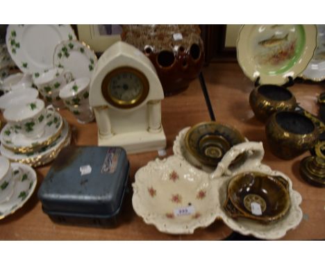 A ceramic mantle clock and similar ceramics