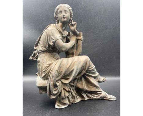 A cast metal classical figure of a lady playing a lyre. (Approximate 26cm H)