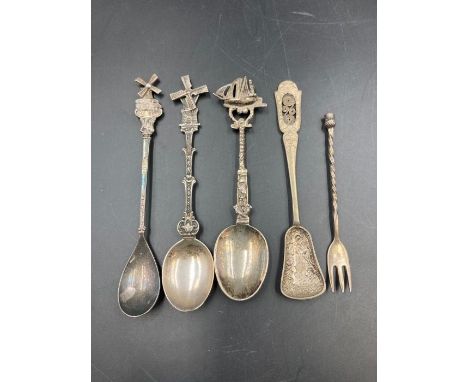 A small selection of four silver spoons and a fork. 