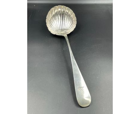 An 18th century silver ladle, with shell style bowl makers mark indistinct. 