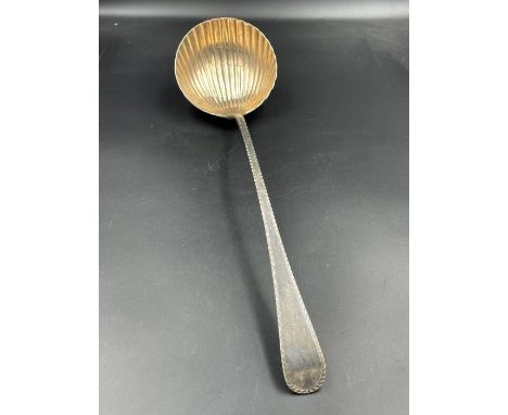 An 18th century silver ladle, with shell style bowl makers mark indistinct. 
