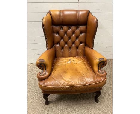 A leather Chesterfield button back wing chair 