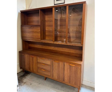 A Mid Century wall unit with glazed cupboard, drink cabinet, drawers and cupboards below (H200cm W193cm D42cm)