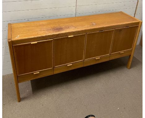 A Mid Century sideboard with four doors to front and drawers under (H86cm W175cm D45cm)