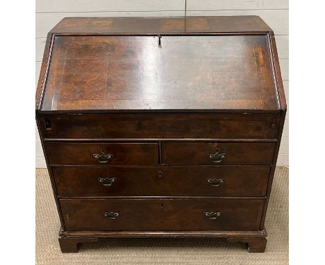 A Queen Anne bureau, the fall front enclosing fitted interior of pigeon holes, drawers and a sliding well followed by two sho
