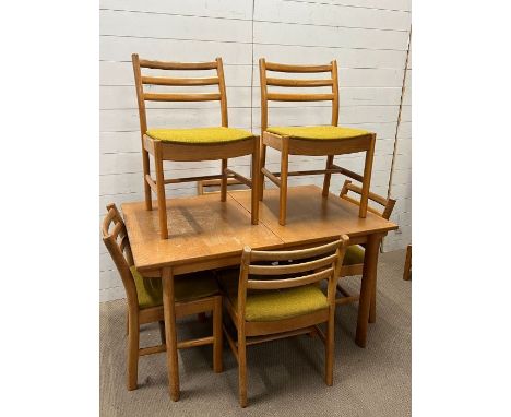 A mid Century dining table with six ladder back chairs (H73cm W130cm D84cm)