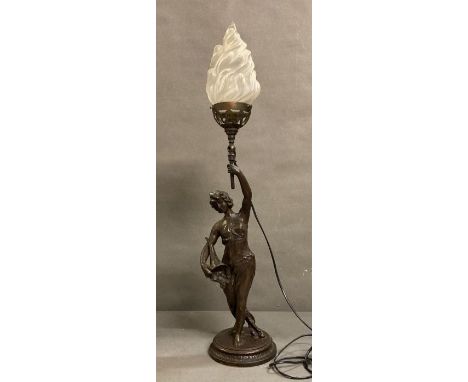 An Art Deco style table lamp of a lady holding a torch 
