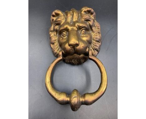 A brass lion shaped door knocker