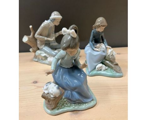 Three Nao figurines, all with animals 