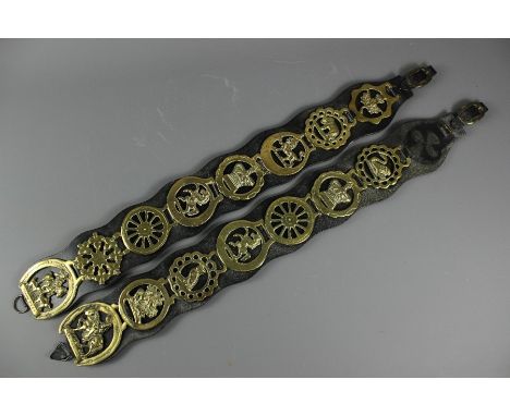 A pair of fireside leather martindales, the first comprising seven horse brasses and the other nine horse brasses, approx 71 