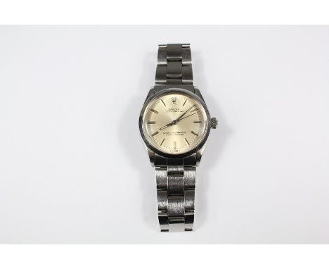 A stainless steel Rolex Oyster Perpetual wrist watch, the watch having a champagne face with baton dial, stamped Superlative 