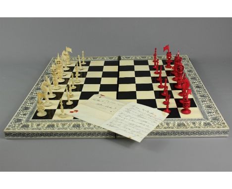 Antique ivory chess set and board; the hinged folding board having foliate decorative inlay, complete with antique carved, st