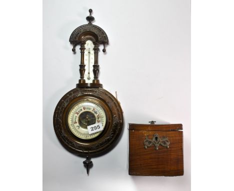A carved oak barometer and a mahogany tea caddy.
