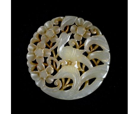 A Chinese carved jade disc of a pheasant among foliage, Dia. 5.8cm, Depth. 0.3cm, probably a 19th century box cover decoratio