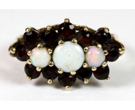 A 9ct gold garnet and opal cluster ring (L).
