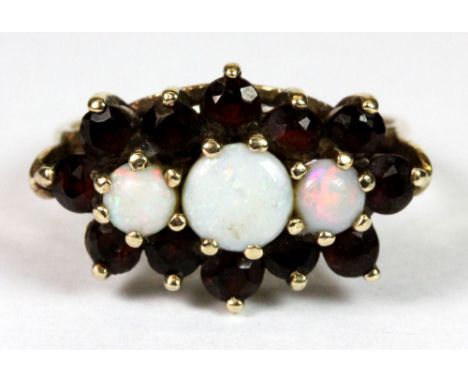 A 9ct gold garnet and opal cluster ring (L).