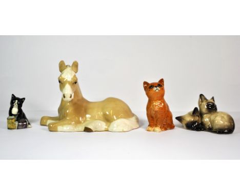 Two Beswick cat figures, a Royal Doulton kitten with two food tins and a ceramic faun.