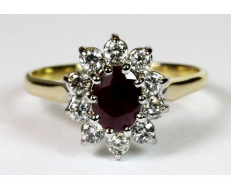 A lovely 18ct yellow gold ruby and diamond cluster ring (R).