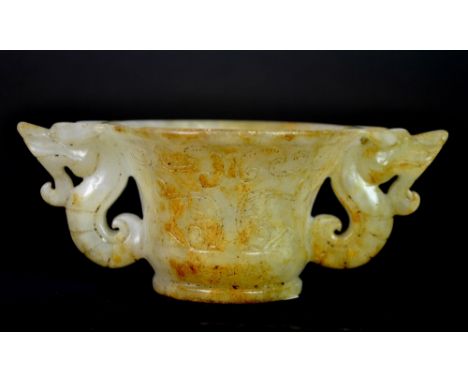 A Chinese archaic form carved jade cup with dragon handles, W. 13cm.