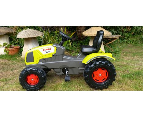 A Claas Pedal Tractor 3-8 years -

A Claas 340 AXOS Pedal Tractor. Age recommendation 3-8 years.  Bonnet opens, adjustable se