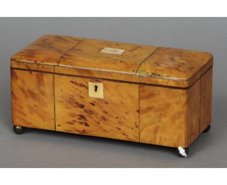 A 19th century tortoiseshell tea caddy
Enclosing two lidded compartments flanking a well, standing on gilt metal ball feet.  