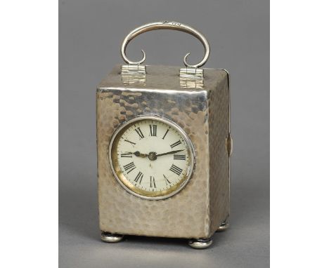An Edward VII beaten silver cased carriage clock, hallmarked Birmingham 1901, maker's mark of HM
The circular dial with Roman