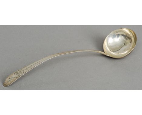 An 18th/19th century bright cut silver ladle, maker's mark of TB
The handle decorated with Prince-of-Wales feathers with a fu