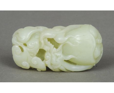 A Chinese carved jade pebble
Worked as a lotus flower.  9 cm long.  CONDITION REPORTS: Generally in good condition, expected 
