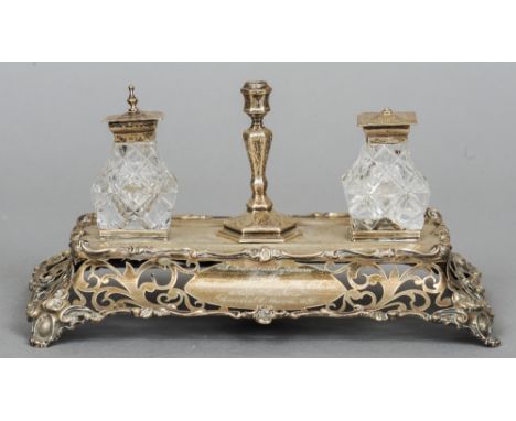 A Victorian silver inkstand, maker's mark of GR
The pierced rectangular base engraved with a presentation inscription and dat