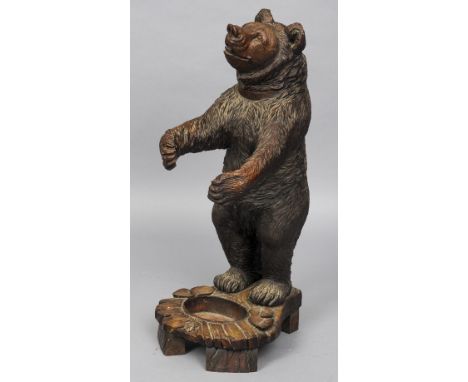 A late 19th century Black Forest carved bear form stick stand
Of typical form, standing on hind legs.  95 cm high. CONDITION 