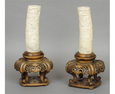 A pair of late 19th/early 20th century Chinese carved ivory tusk sections
Each worked in the round with figures in traditiona