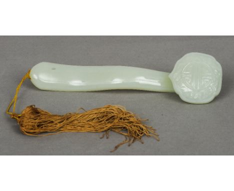 A Chinese carved jade ruyi sceptre
Typically worked with gilt six character Qianlong mark.  23 cm long.  CONDITION REPORTS: G