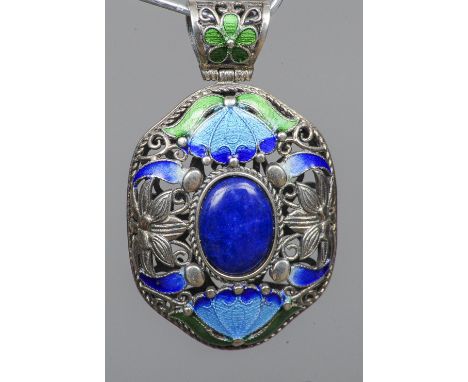 A Chinese pierced silver and enamel decorated pendant
Centred with a lapis cabochon.  5.5 cm high. CONDITION REPORTS: Overall