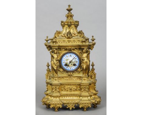 A 19th century ormolu mantel clock
The ornately scroll cast case centred with a painted porcelain dial with Roman numerals fl